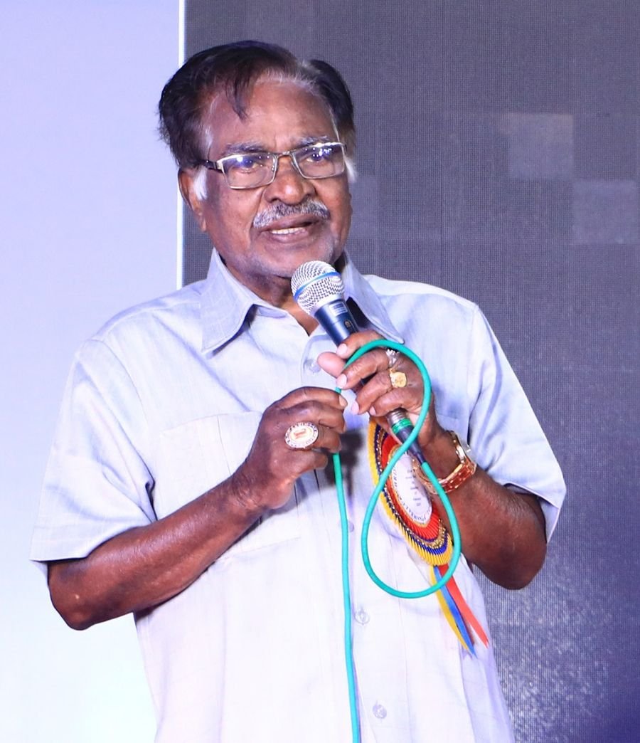 Dr. M. Christopher speaking on stage